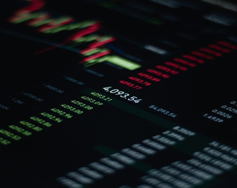 Close-up of a dark stock trading screen with green and red numbers and a central 4,092.54.