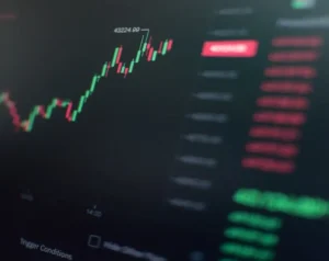 Candlestick trading chart on a dark dashboard showing an upward price move, with a highlighted 43224.99 and a blurred right-side panel of quotes and metrics.